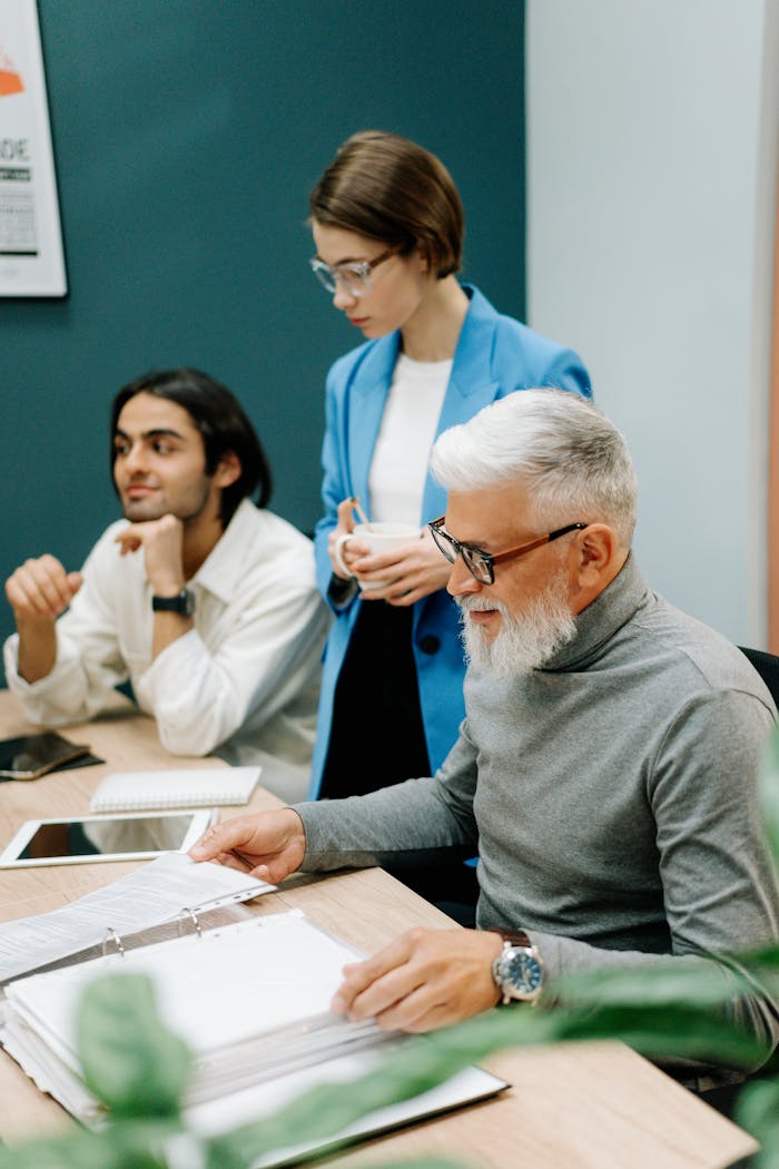 A diverse group of colleagues engaged in a collaborative business meeting.